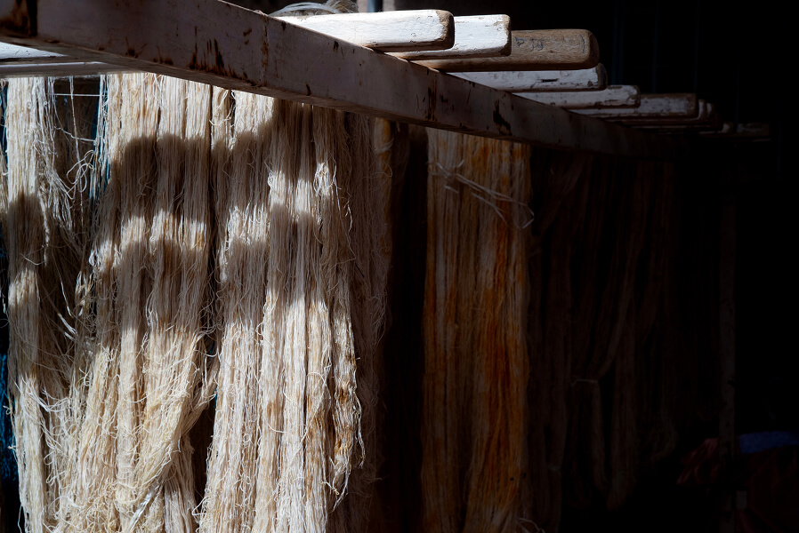 Washed hanks of cotton are hung to dry, allowing the atmosphere to set the material.