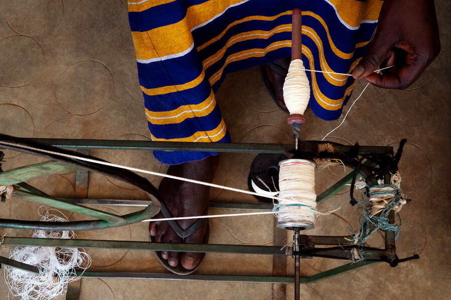 The winding of yarn, ensuring the thread is refined and ready for weaving.